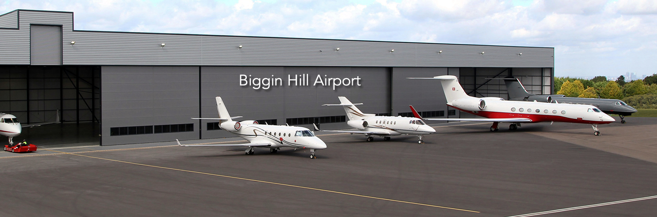 Executive chauffeur waiting on tarmac for private jet arrival at London Biggin Hill Airport