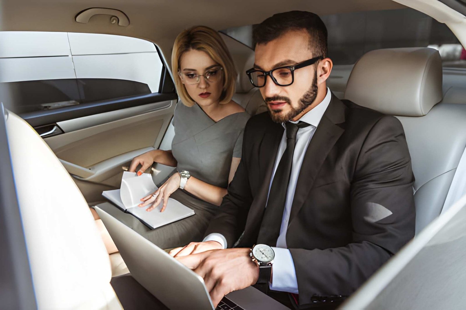 Executive stepping into a chauffeur-driven car in central London