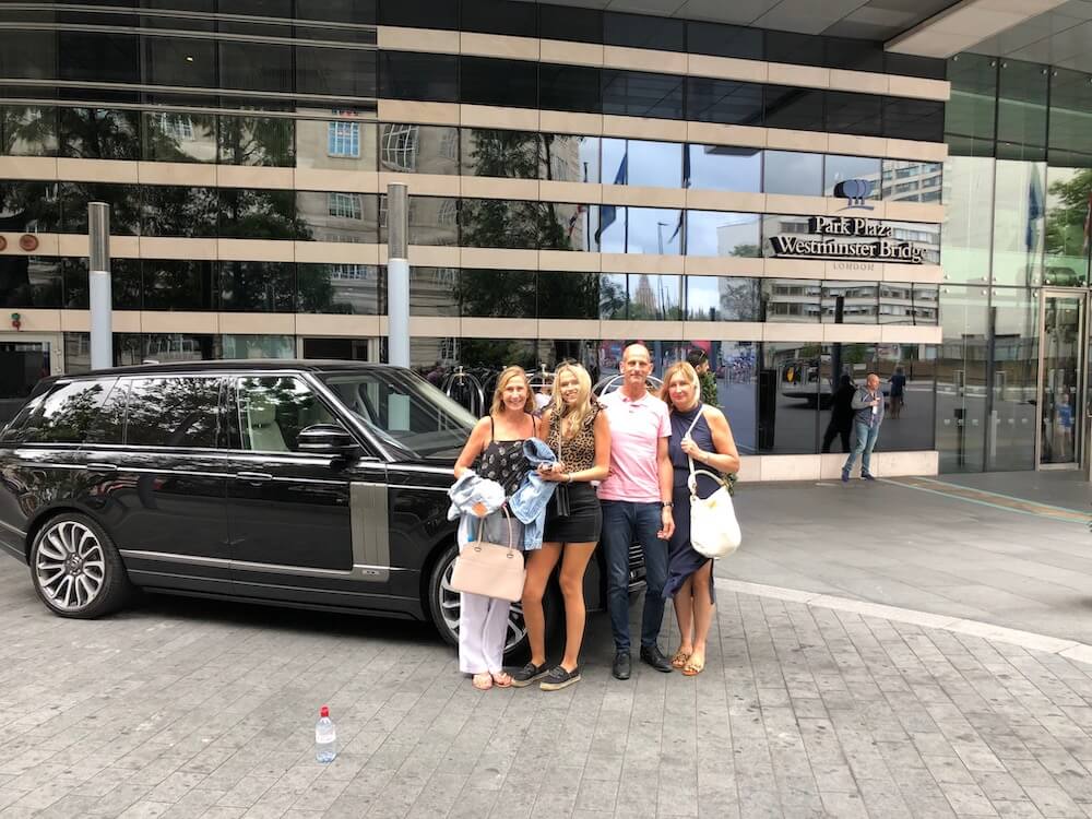 Passengers viewing an illuminated London landmark during a chauffeur-driven evening tour