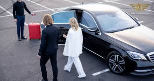 Chauffeur holding door open for an executive in London
