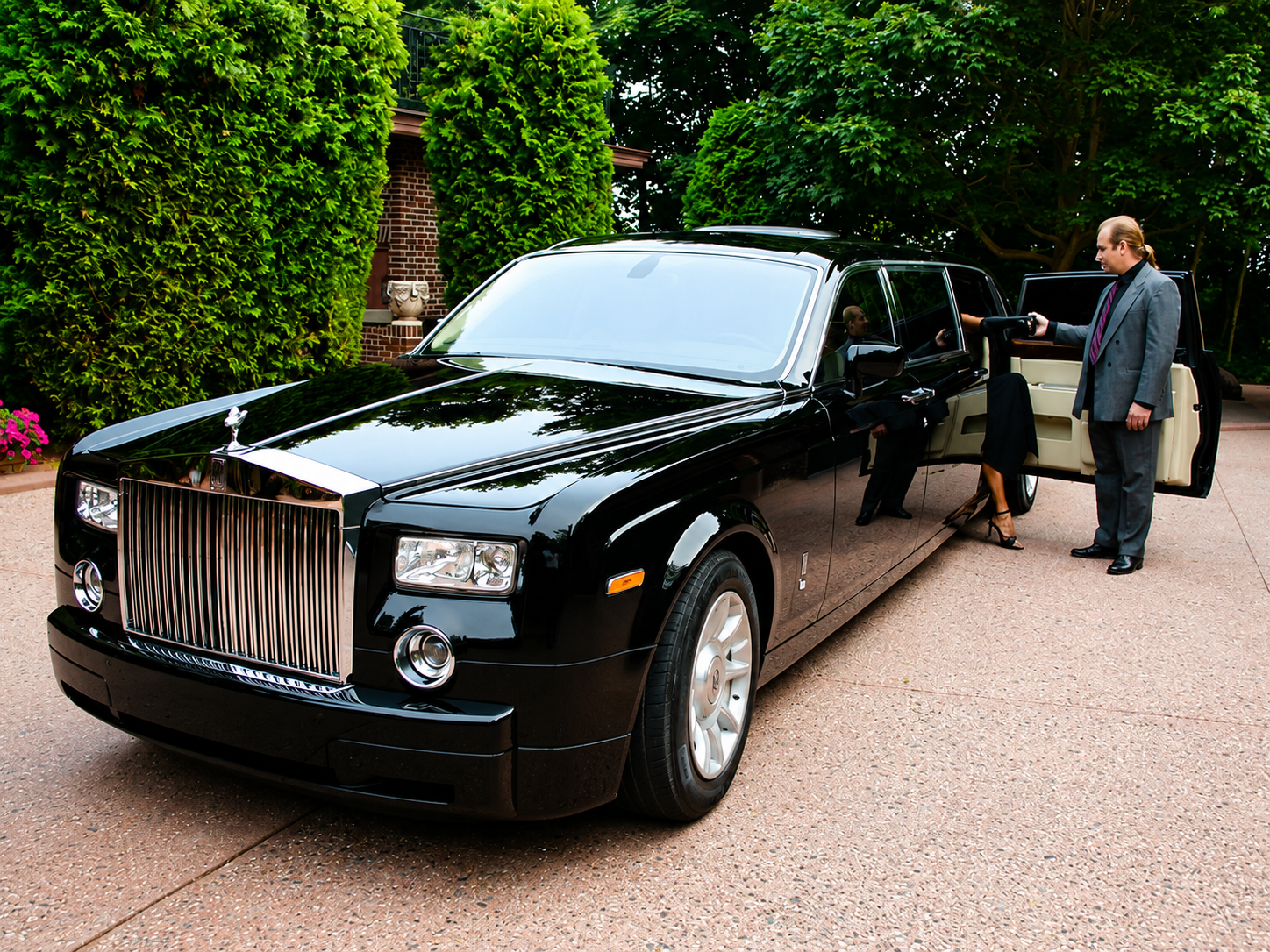 Chauffeur opening the door of a luxury vehicle for a passenger in London