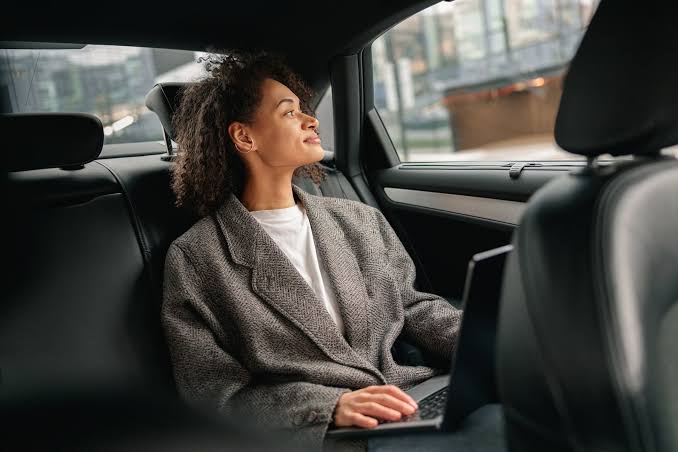 Passengers boarding luxury chauffeured car for a private London sightseeing tour