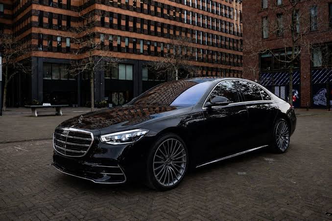 Interior view of a luxury chauffeured vehicle cabin driving through West London