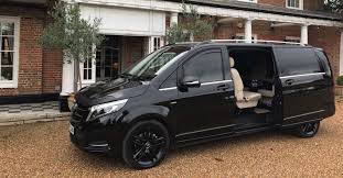 Sleek luxury Mercedes-Benz chauffeur vehicle driving through Central London during the day