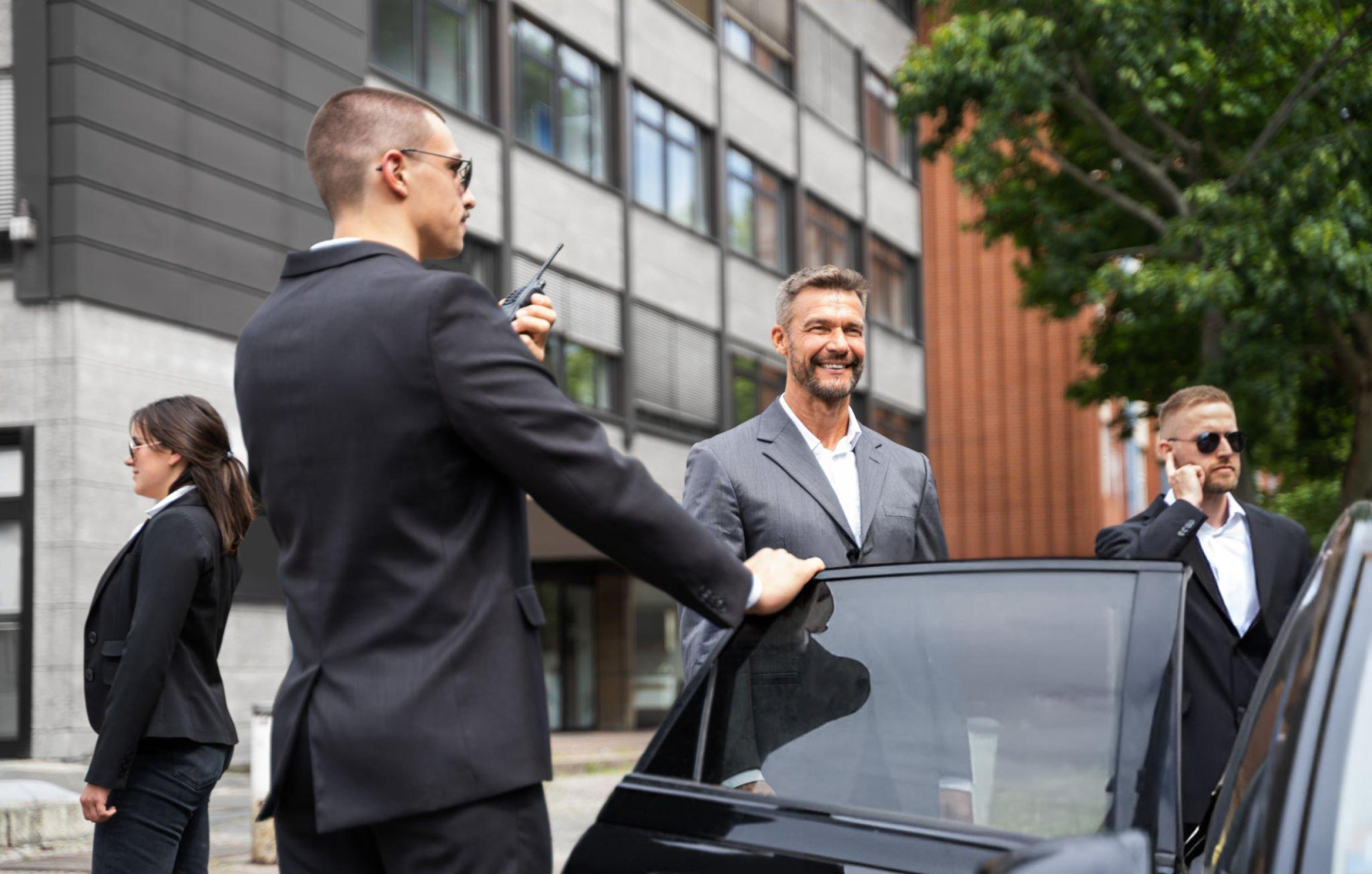 Chauffeur assisting a passenger with luggage at St Pancras International